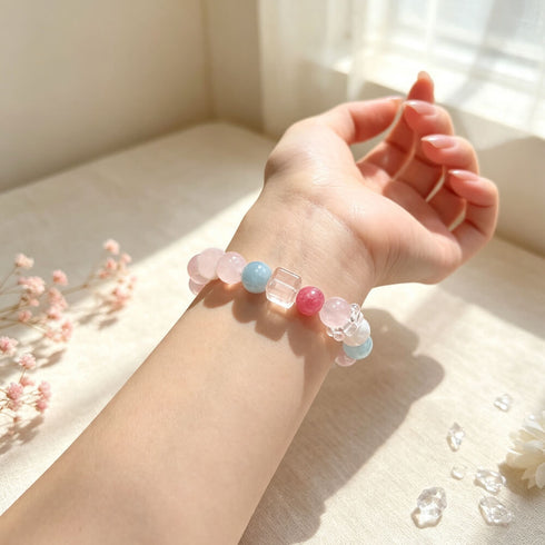 Beaded crystal bracelet on wrist with pink, blue, and clear accent beads