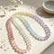 Rainbow beaded bracelet with pink, mint, blue, and purple round gemstone beads