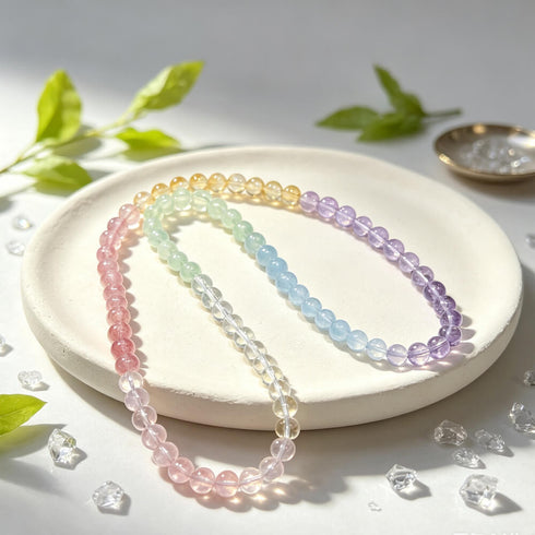 Pastel rainbow beaded bracelet on white tray with pink, mint, blue, and purple beads