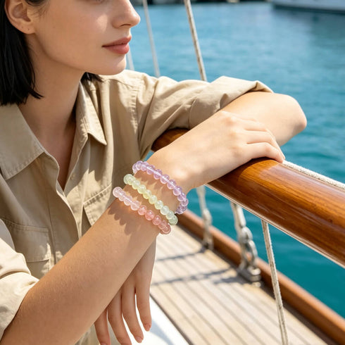 Pastel rainbow gemstone bead bracelet on wrist in rose, mint, blue, and lavender tones