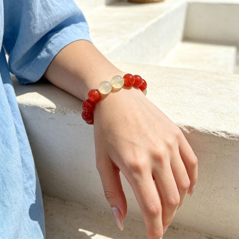Red and clear beaded crystal bracelet with round stones, worn on wrist