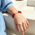 Red and clear beaded crystal bracelet with round stones, worn on wrist