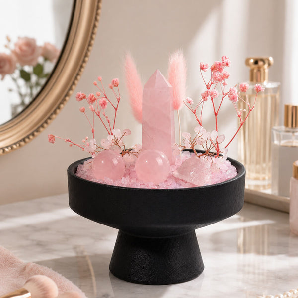 Round black tray pedestal crystal display with pink rose quartz tower, spheres, and blooms