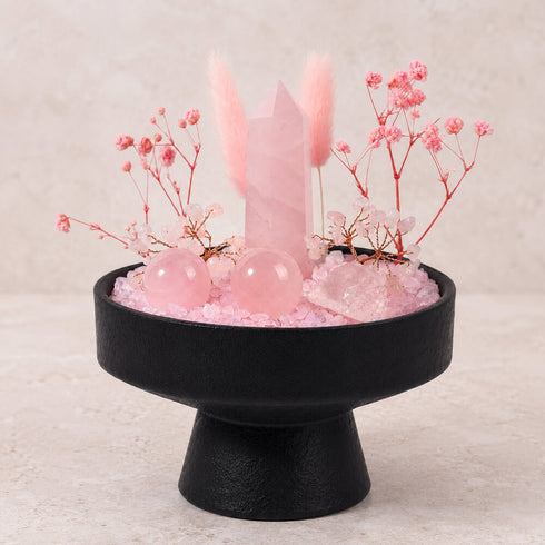 Front view crystal display: black pedestal base with pink rose quartz tower and spheres