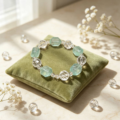 Women’s crystal beaded bracelet on green cushion, clear and light aqua faceted beads