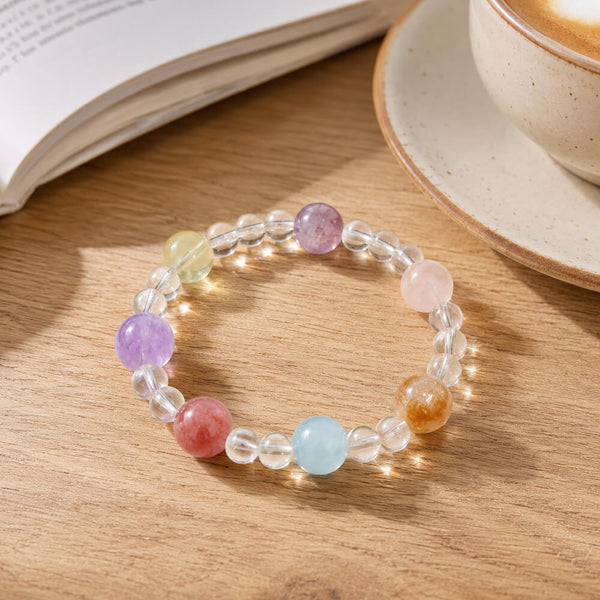 Crystal bead bracelet featuring clear links and round lavender, pink, blue, and orange stones