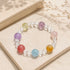 Multicolor crystal charm bracelet with clear beads and round pink, purple, blue, and yellow stones