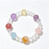 Crystal stretch bracelet with clear beads and pastel purple, pink, blue, and amber round charms