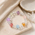 Beaded crystal bracelet with clear spacer beads and multicolor round stone charms