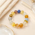 Multicolor beaded crystal bracelet with round yellow, blue, and clear gemstone beads