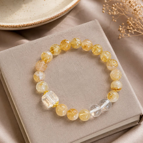 Gold and clear crystal bracelet with round beads and clear faceted cube charms