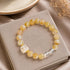 Gold and clear crystal bracelet with round beads and clear faceted cube charms