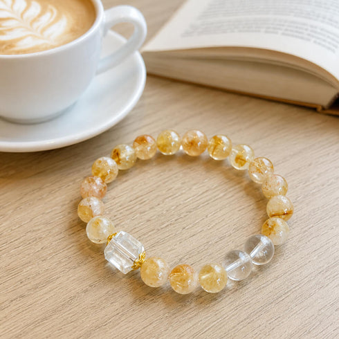 Gold and clear crystal beaded bracelet with round beads and two clear cube accents