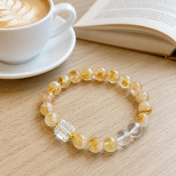 Gold and clear crystal beaded bracelet with round beads and two clear cube accents