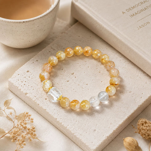 Gold and clear crystal bracelet with round beads and clear faceted cube details on stretch cord