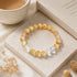 Gold and clear crystal bracelet with round beads and clear faceted cube details on stretch cord